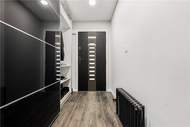 interior space with radiator heating unit and hardwood / wood-style floors