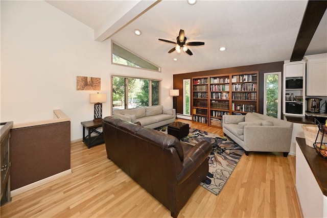 living room with vaulted ceiling with beams, ceiling fan, a baseboard radiator, and light wood-type flooring