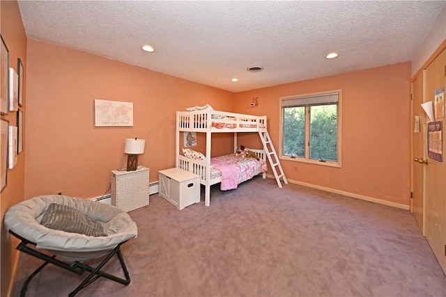 bedroom featuring carpet flooring, a textured ceiling, and a baseboard heating unit