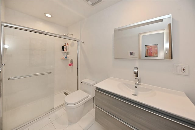 bathroom featuring tile patterned floors, vanity, toilet, and walk in shower