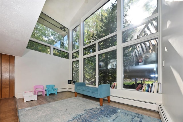 unfurnished sunroom with a baseboard heating unit