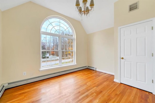 empty room with a notable chandelier, lofted ceiling, light wood-type flooring, and a baseboard heating unit