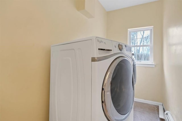 clothes washing area featuring light tile patterned flooring, washer / clothes dryer, and a baseboard radiator