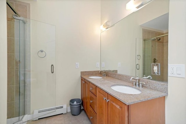 bathroom featuring tile patterned flooring, vanity, baseboard heating, and walk in shower