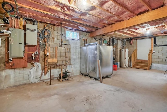 basement with fridge, electric panel, and water heater