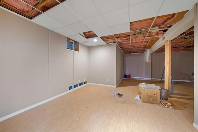 basement with hardwood / wood-style flooring