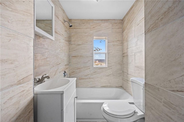 full bathroom with vanity, tiled shower / bath combo, tile walls, and toilet