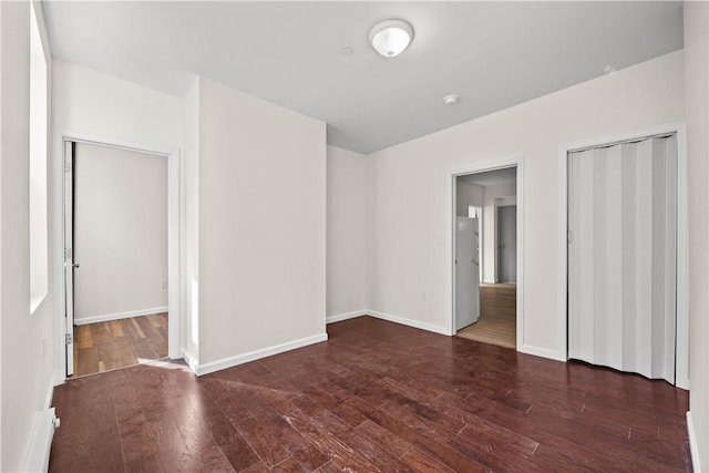 empty room with dark hardwood / wood-style floors