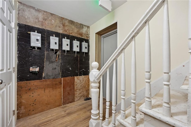 interior space with wood-type flooring and tile walls