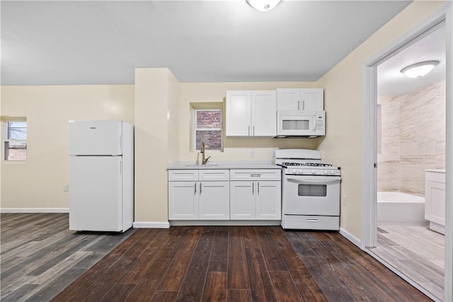 kitchen featuring white cabinets, white appliances, dark hardwood / wood-style floors, and sink