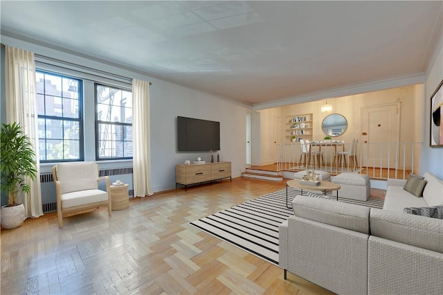 living room featuring ornamental molding, radiator heating unit, and light parquet floors