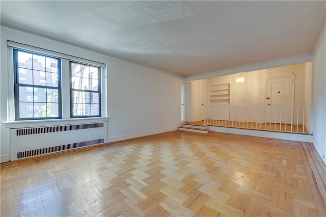 unfurnished room with radiator, crown molding, and light parquet floors