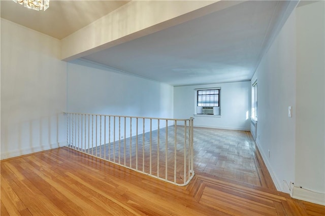 unfurnished room featuring crown molding, cooling unit, and an inviting chandelier