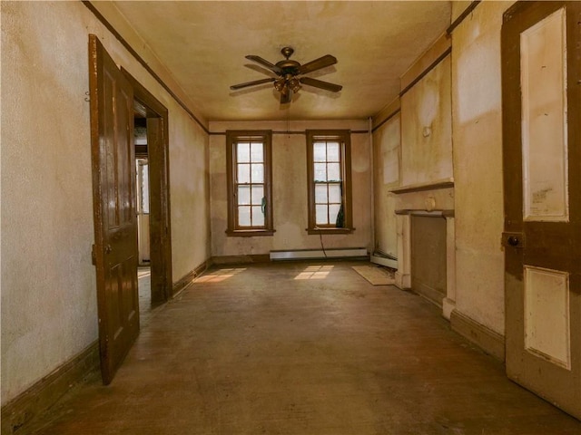 misc room with ceiling fan and a baseboard heating unit