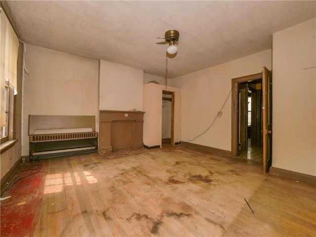 unfurnished room with wood-type flooring and ceiling fan