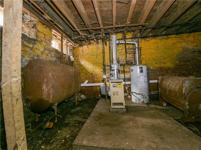 basement featuring gas water heater and brick wall