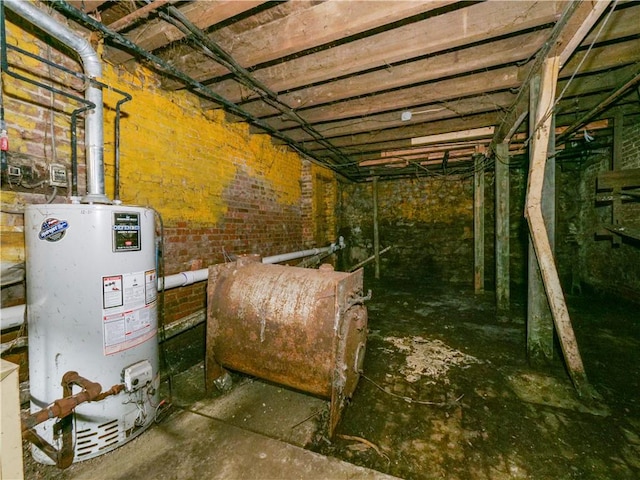 interior space with gas water heater and brick wall