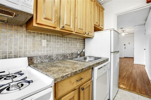 kitchen featuring white appliances, backsplash, sink, ceiling fan, and light hardwood / wood-style floors