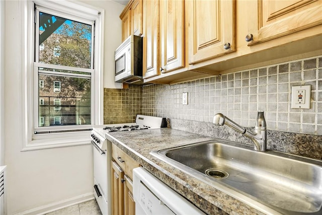 kitchen with light brown cabinetry, tasteful backsplash, white range, sink, and light tile patterned floors