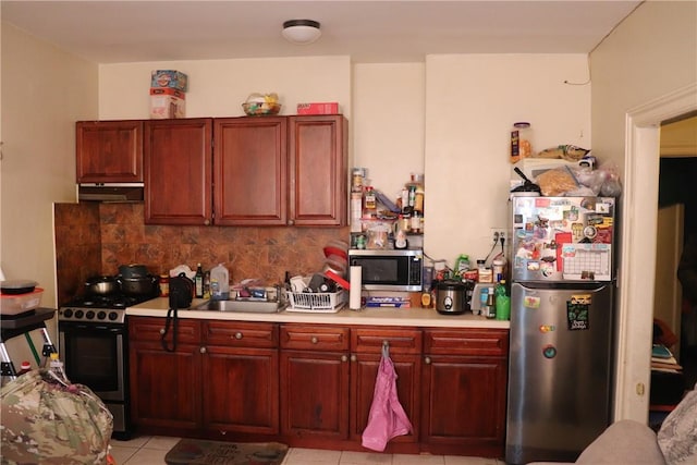 kitchen with sink, stainless steel appliances, tasteful backsplash, and light tile patterned flooring