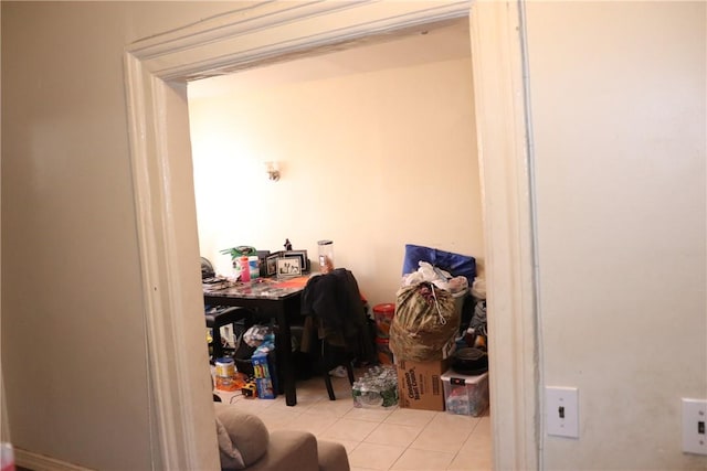 clothes washing area with light tile patterned floors