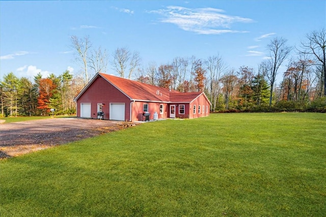 view of front of house with a garage, driveway, and a front lawn