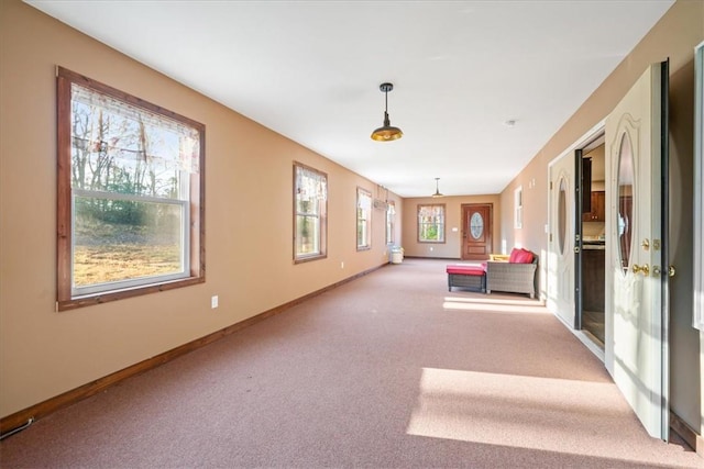 interior space with carpet and baseboards