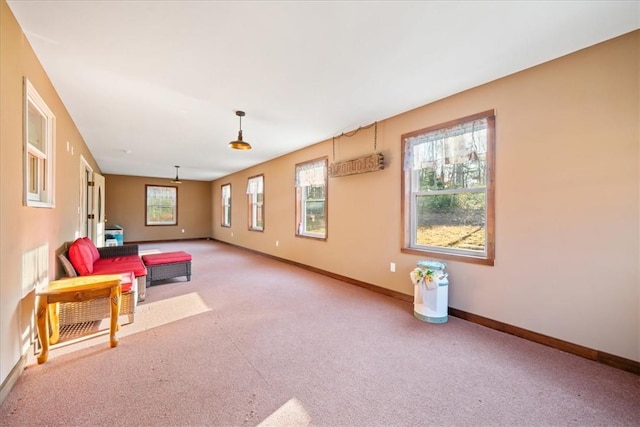 sitting room with carpet and baseboards