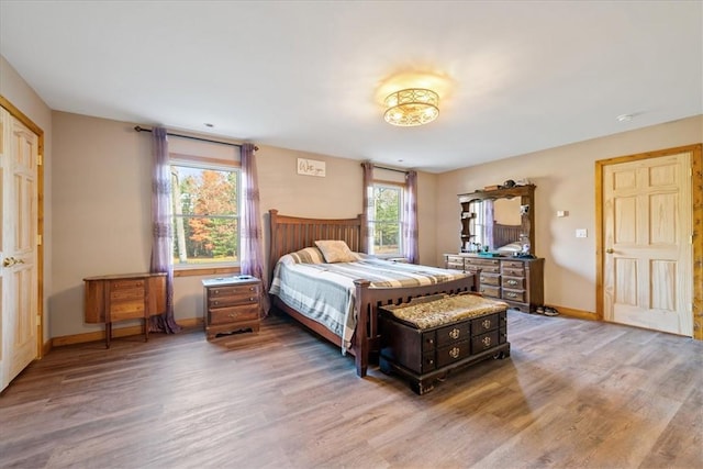 bedroom featuring baseboards and wood finished floors