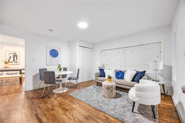 living room with wood-type flooring and baseboard heating