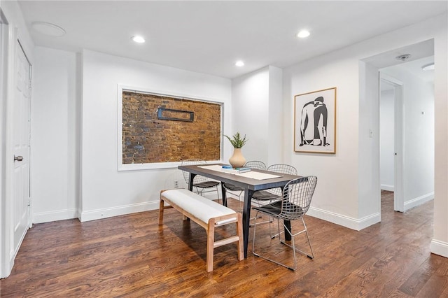 dining area featuring dark wood-type flooring