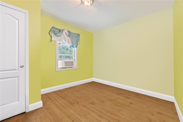 unfurnished room with wood-type flooring and cooling unit