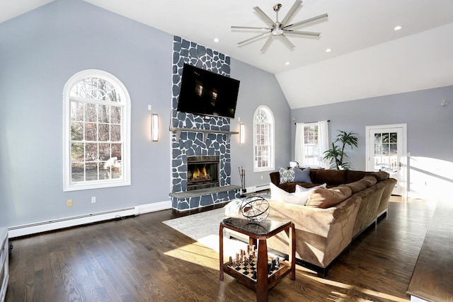 living room featuring a stone fireplace, a baseboard heating unit, dark hardwood / wood-style flooring, and lofted ceiling