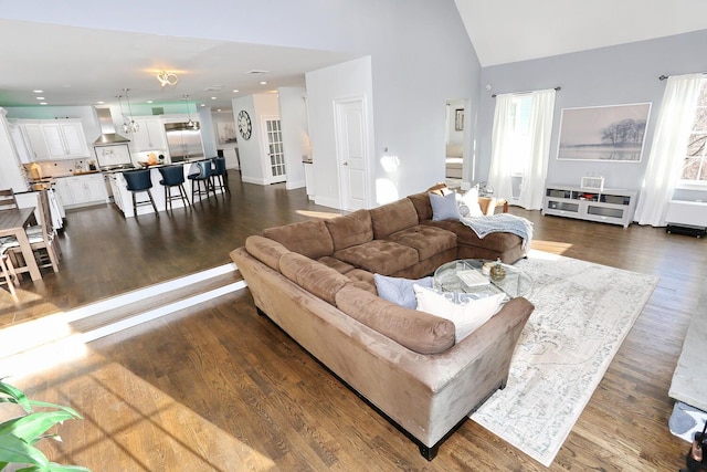 living room with dark hardwood / wood-style flooring and lofted ceiling