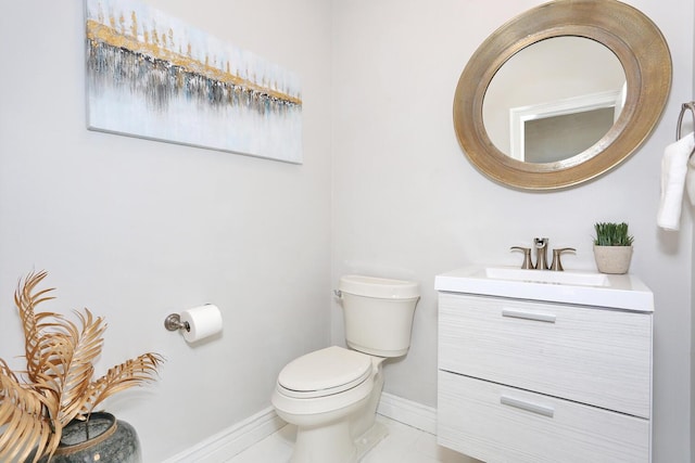 bathroom with vanity, toilet, and tile patterned flooring