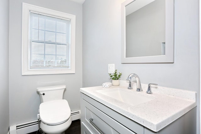 bathroom featuring vanity, toilet, and a baseboard radiator