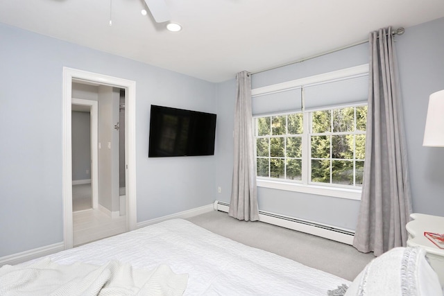 carpeted bedroom featuring baseboard heating