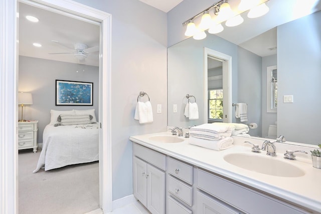 bathroom featuring toilet, ceiling fan, and vanity