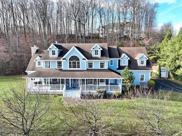 view of front of property with a porch and a front lawn