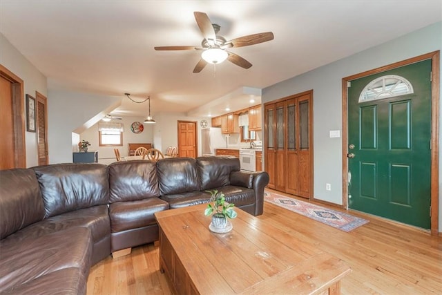 living room featuring ceiling fan and light wood-type flooring