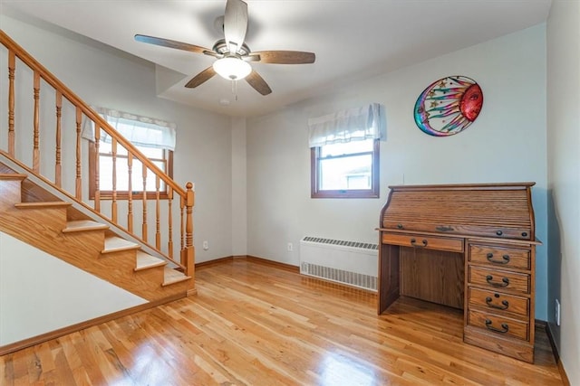 interior space featuring radiator, ceiling fan, and light hardwood / wood-style flooring