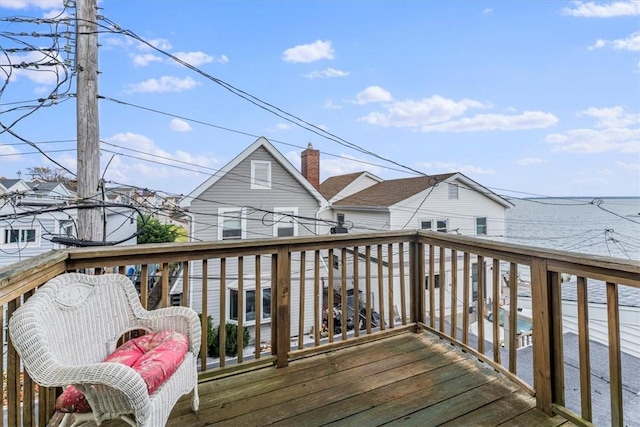 wooden terrace featuring a water view