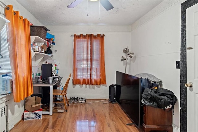 office with wood-type flooring, a textured ceiling, and ceiling fan