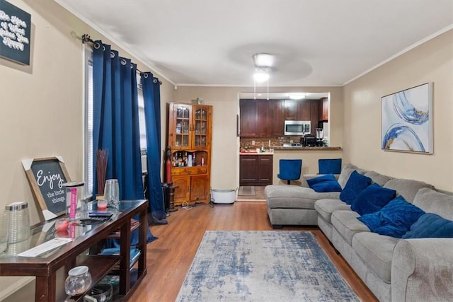 living room featuring crown molding and light wood-type flooring