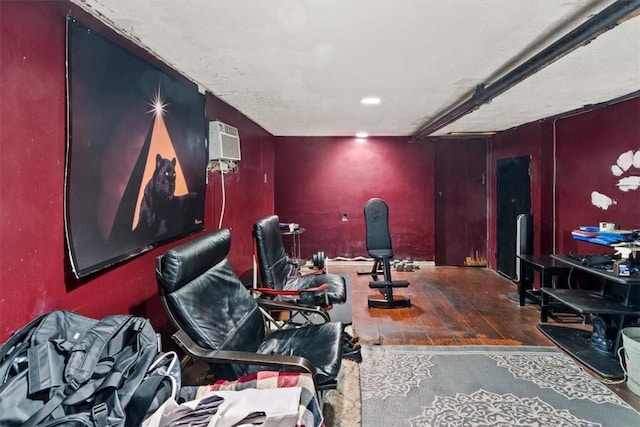 misc room with wood-type flooring and an AC wall unit