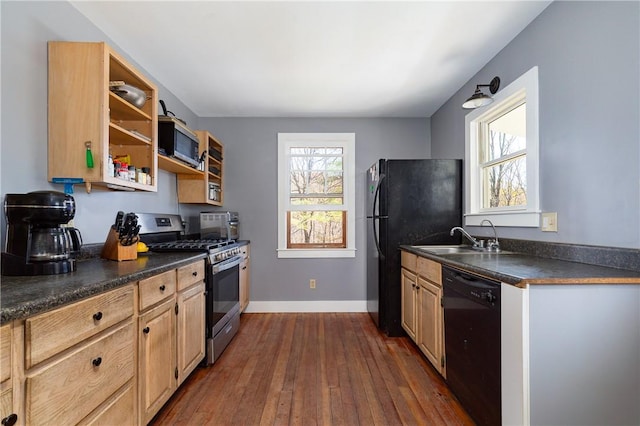 kitchen featuring black appliances, a healthy amount of sunlight, sink, and dark wood-type flooring