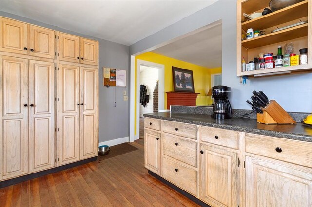 kitchen with dark hardwood / wood-style flooring and light brown cabinetry