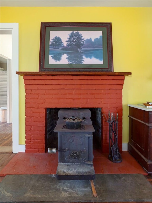 room details featuring a wood stove and hardwood / wood-style flooring