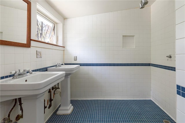 bathroom with tile patterned floors, tasteful backsplash, vaulted ceiling, and tile walls