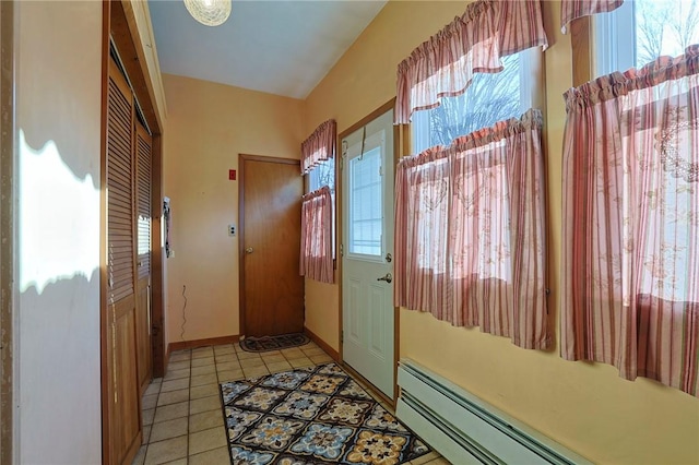 doorway featuring light tile patterned floors and a baseboard heating unit